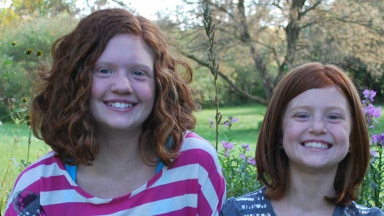 Two smiling girls with red hair